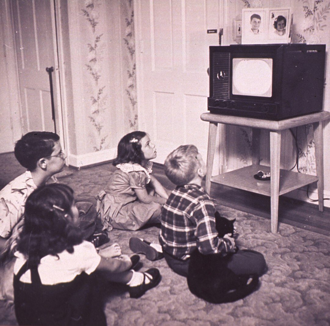 family watching sports on old tv